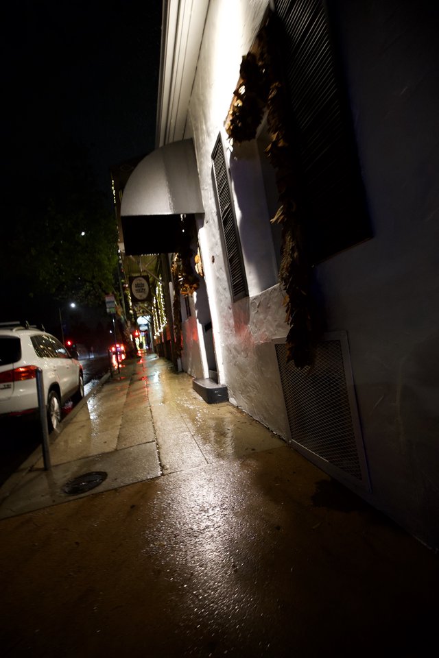 Wet City Street at Night with Holiday Lights