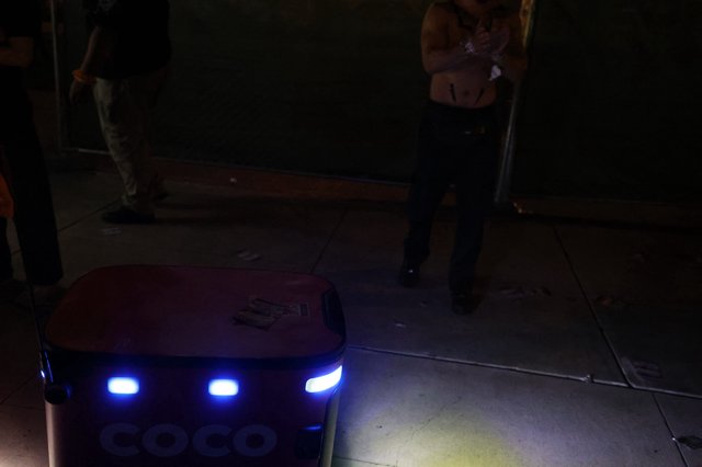 Coco Delivery Robot Navigates Nighttime Festival Crowd