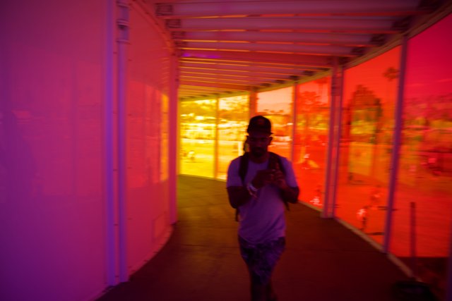 A Colorful Transition: Man Navigating Through Vivid Corridors