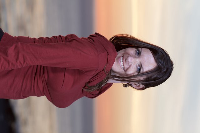 Smiling Woman at Golden Hour Coastal Sunset