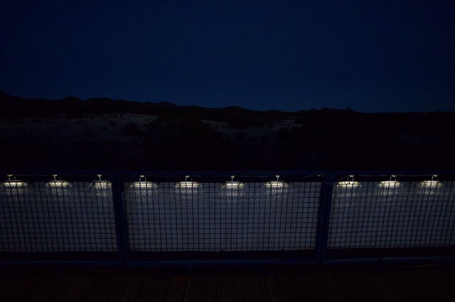 Illuminated Industrial Facility at Twilight in Desert Mountains