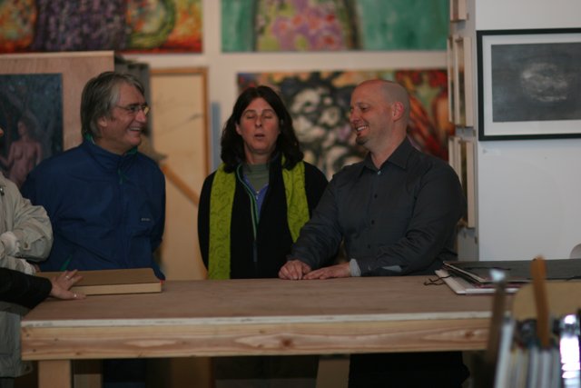 A Trio of Art Lovers in Front of a Plywood Table