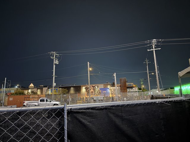 Industrial Night Scene with Power Lines and Graffiti