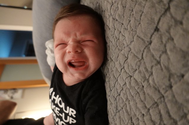 Joyful Baby Laughing on Textured Blanket
