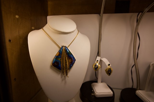 Artisan Jewelry Display with Blue and Gold Pendant