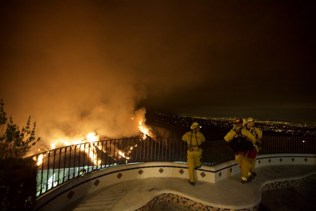 Firefighters Observe the Blaze from the Hillside