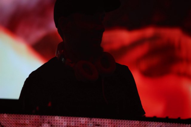 DJ Silhouette Bathed in Red Stage Light