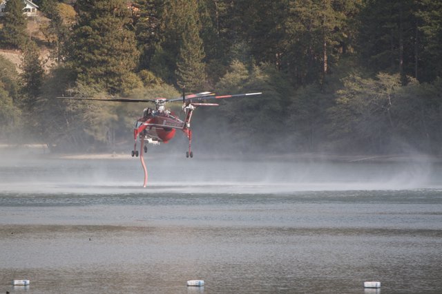 Helicopter Combatting Wildfires with Water Spray