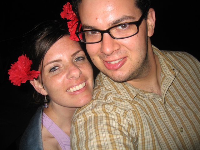 Happy Couple with Red Flowers at Evening Event