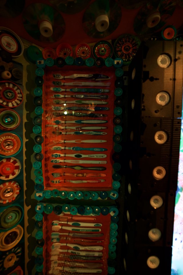 Colorful Folk Art Display with Toothbrushes and Buttons