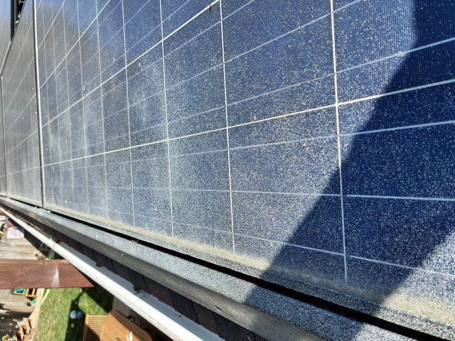 Dusty Solar Panels on Residential Rooftop Installation