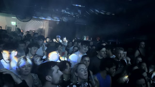Crowded Underground Club Night with Smoke and Lights