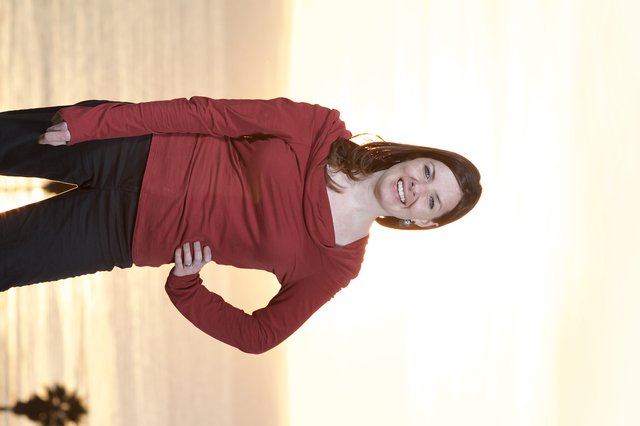 Woman in Red Smiling at Golden Ocean Sunset