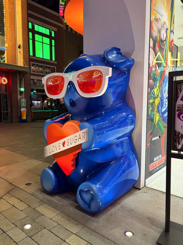 Blue Bear Sculpture with Heart and Sunglasses at Night