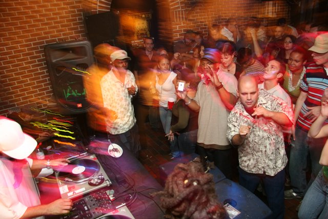 Nightclub Party with High Energy Crowd and DJ Equipment