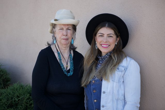 Two Women in Hats and Jeans Strike a Pose