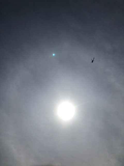 Haloed Plane in Midday Sky