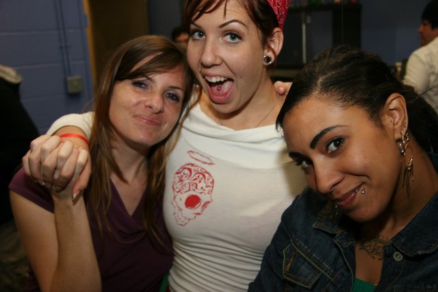 Three Friends Pose Together at a Party
