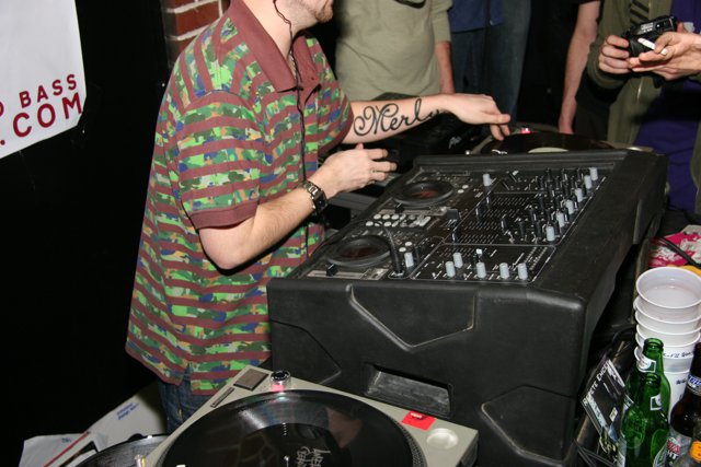 Green-Shirted DJ Spins Beats at Christmas Party