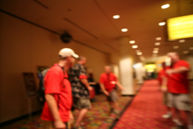 Blurry Group Walks Down Hallway