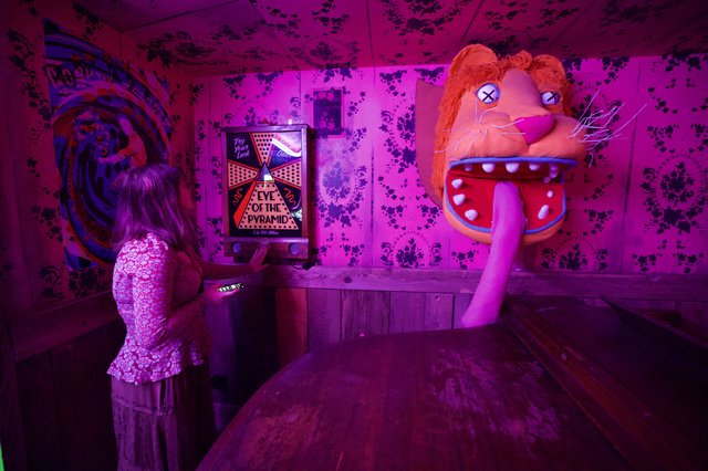 Fortune Teller Machine in Purple-Lit Arcade Room