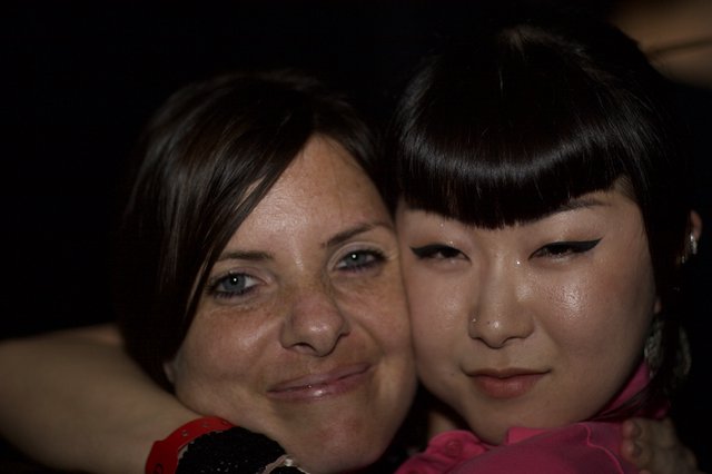 Two Women Share a Close Moment at Night Event