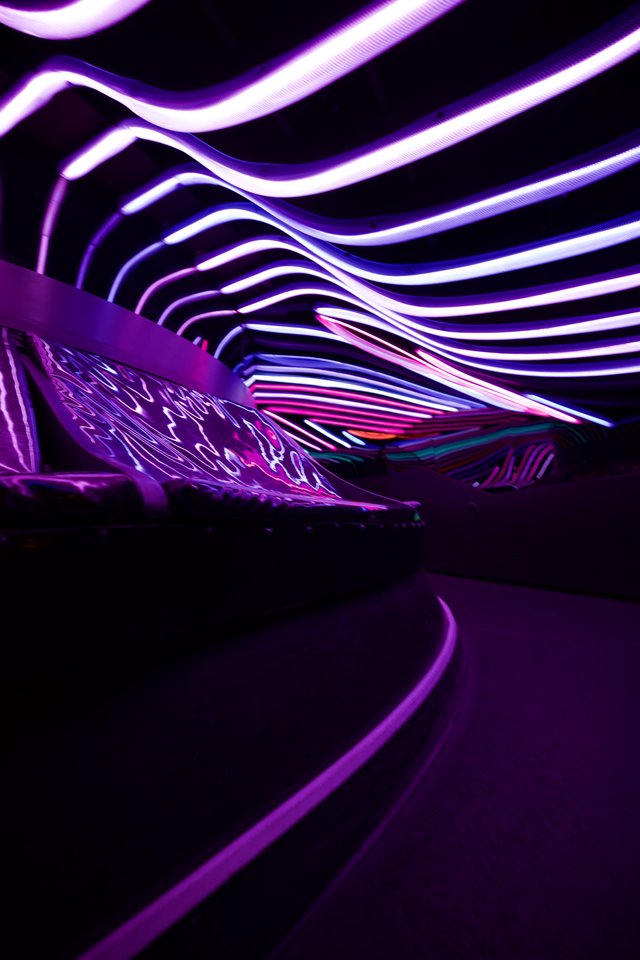 Immersive Purple Light Installation with Flowing Waves