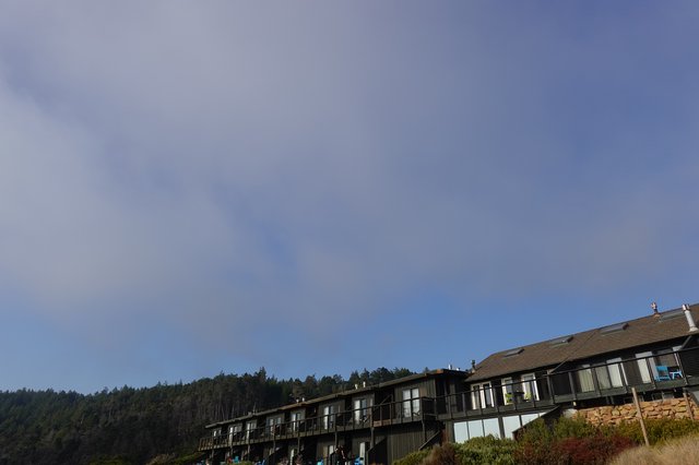 Modern Hillside Condominiums Against Forested Mountains