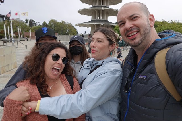 Friends Taking Joyful Group Selfie at Pagoda