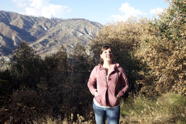 Joyful Woman Smiling in Mountain Wilderness Setting