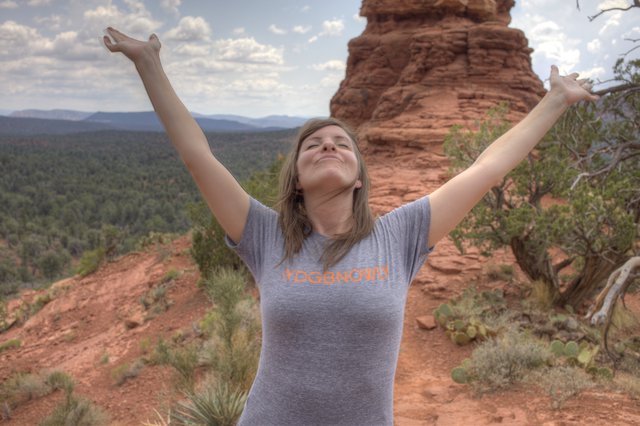 Joyful Woman Embracing Freedom Atop Sedona Red Rocks