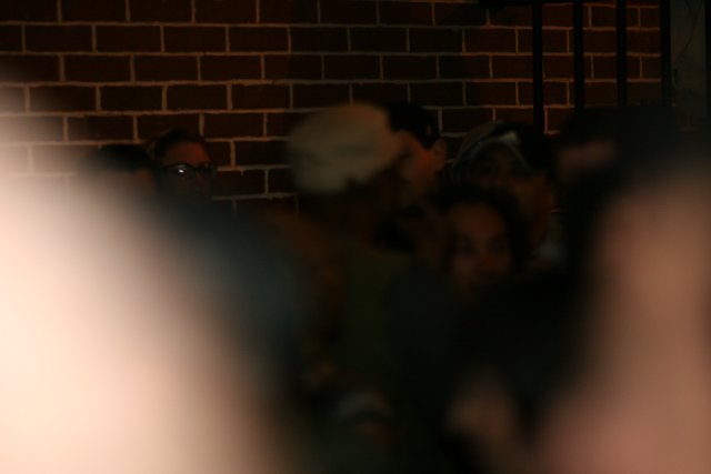 Blurry Crowd at Brick Wall