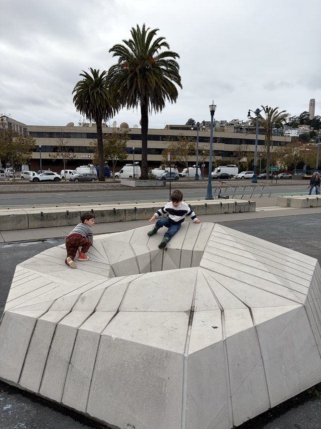 Children Playing on Modern Urban Sculpture Installation