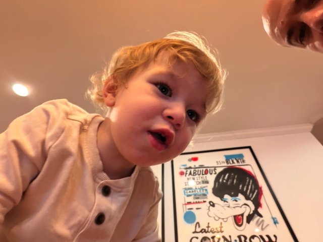 Toddler's Excited Expression Over Colorful Comic Book