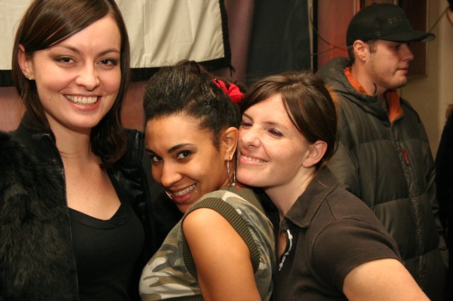 Three Friends Posing Together at a Party