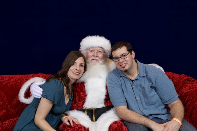 Couple Poses with Santa at Christmas Party