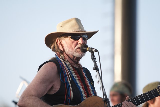 Willie Nelson Rocks the Festival in his Signature Hat and Sunglasses