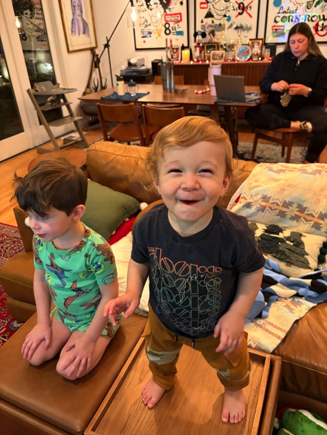 Joyful Toddler Standing on Coffee Table at Home