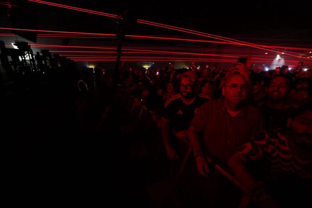 Red Laser Light Show Over Massive Concert Crowd
