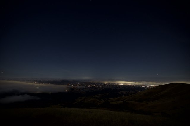City Lights Glowing Beneath a Sea of Fog