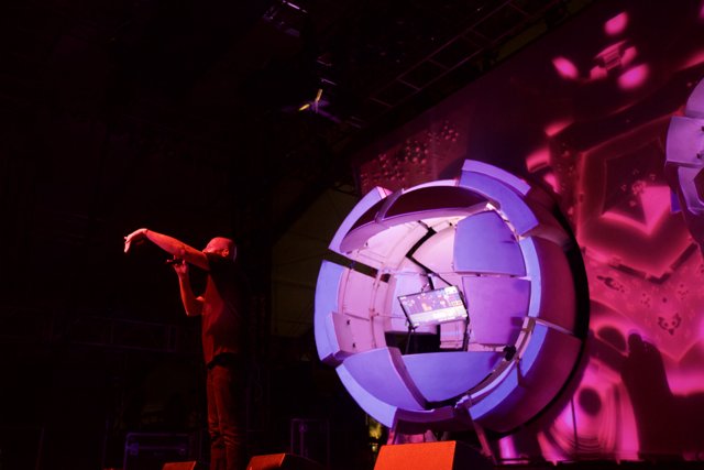 Man on Stage with Futuristic Purple Screen