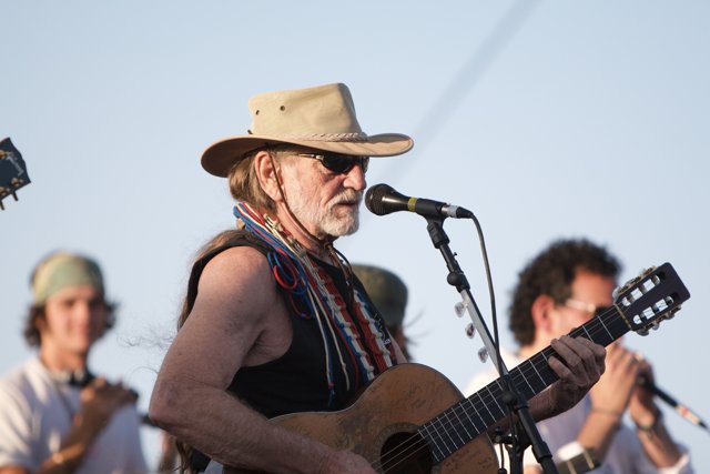 Willie Nelson strums his guitar under the California sky