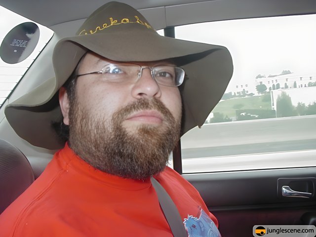 Man in Hat and Beard in Car