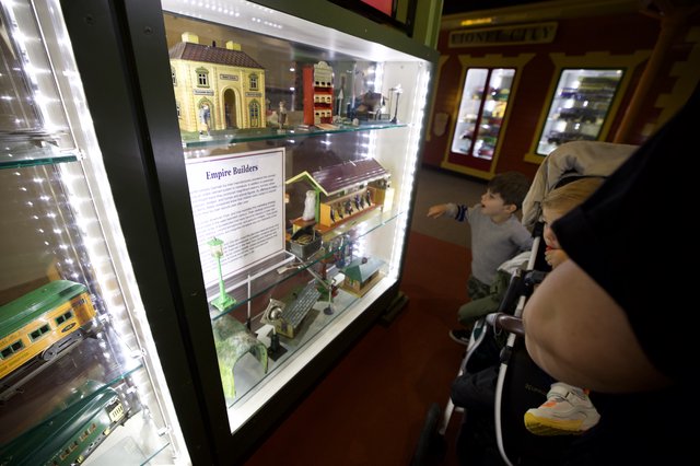 Family Exploring Model Train Display at Museum