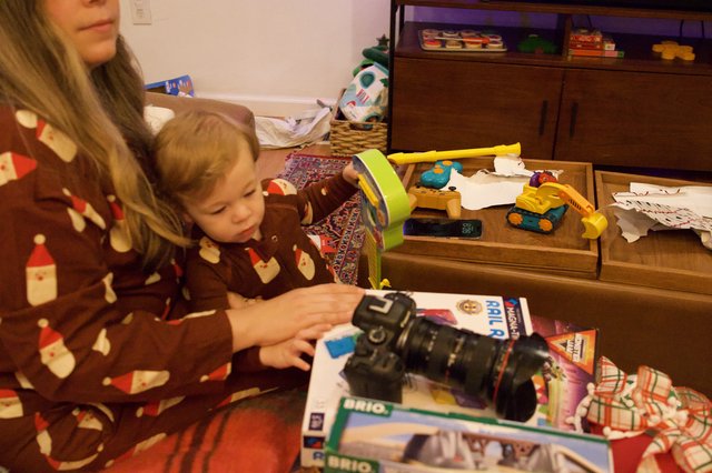 Child Opening Christmas Present with Camera