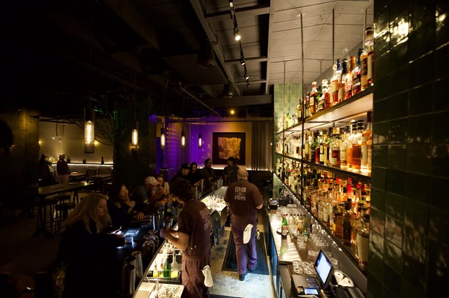 Upscale Cocktail Bar with Illuminated Bottle Display