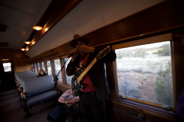 Train Musician Performing During Scenic Desert Journey