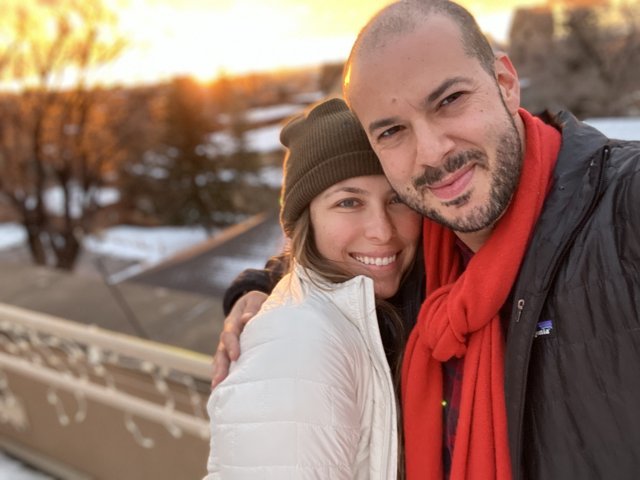 Smiling Couple in Winter Wear Takes a Selfie Together