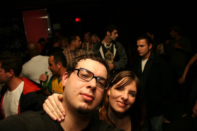 Friends Posing Together at a Crowded Nightclub