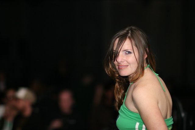 Woman in Green Halter Top Glances Over Shoulder